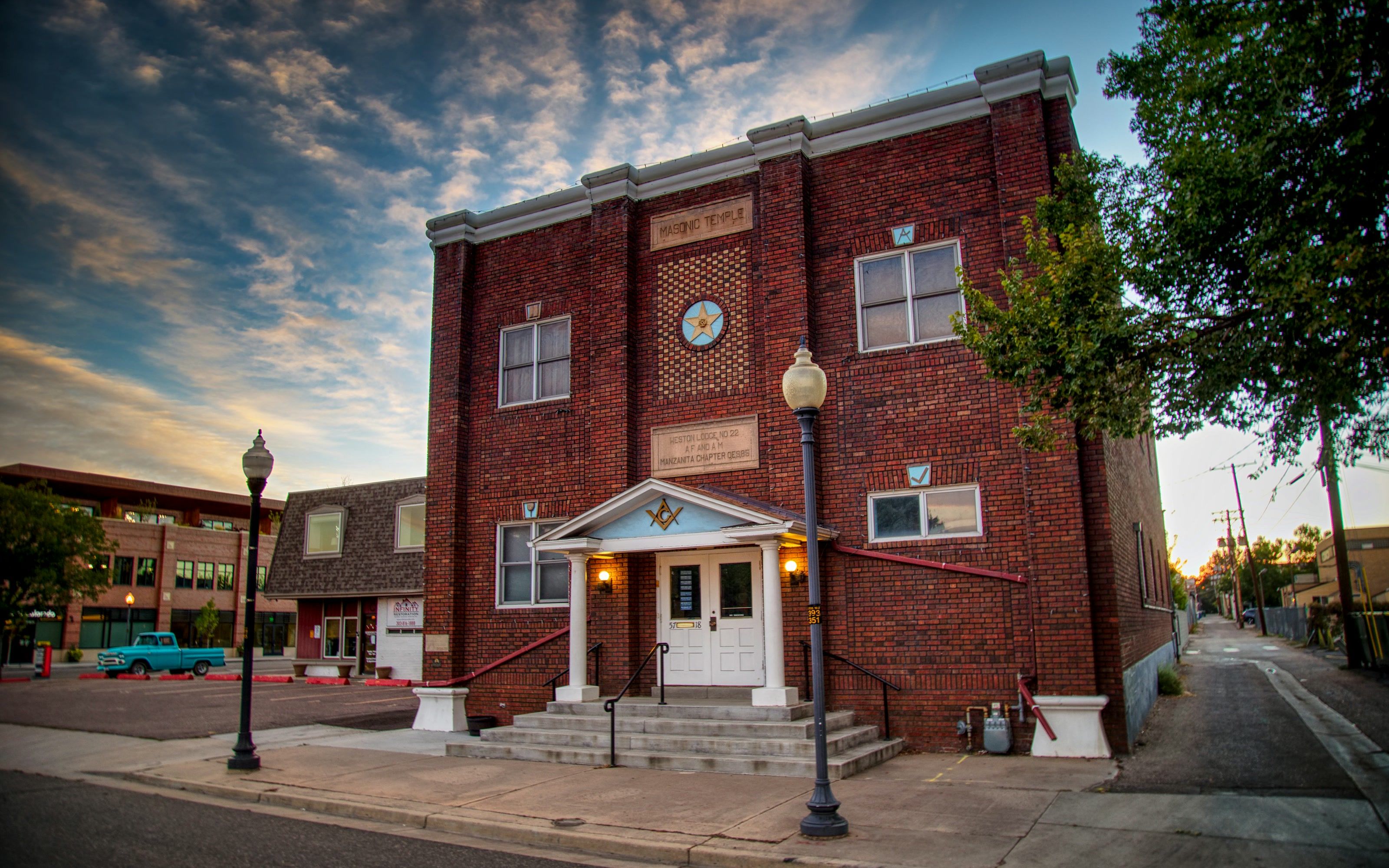 The historic red-brick Masonic Temple in Littleton at sunset